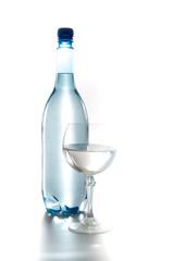 Blue bottle of water with a glass isolated