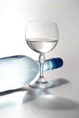 Glass of water with a bottle isolated
