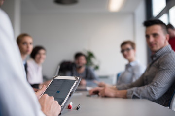 close up of  businessman hands  using tablet on meeting