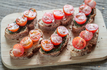 Toasts with tahini and mint sauce and cherry tomatoes