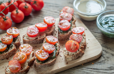 Toasts with tahini and mint sauce and cherry tomatoes