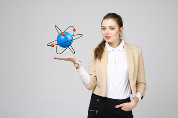 Woman scientist with atom model, research concept