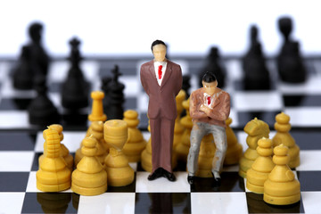 Businessman model on chess board.