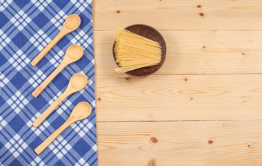 Tablecloth, wooden spoon, on wood textured background