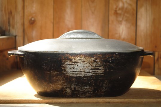 big iron pot on a wooden background