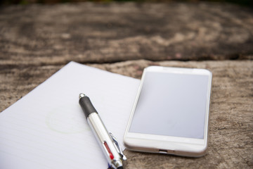 Pen and Notepad on the wooden desk