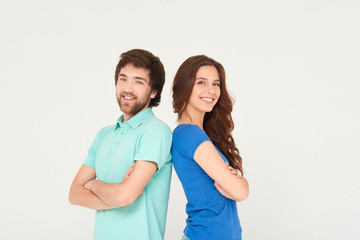 Obraz premium Happy couple standing on white background back to back