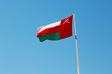 in oman waving flag and the cloudy sky