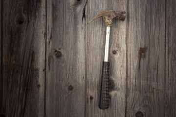 Rusty and grungy old tool on dark wood background
