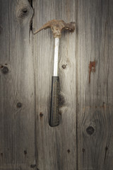 Rusty and grungy old tool on dark wood background
