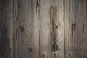 Rusty and grungy old tool on dark wood background