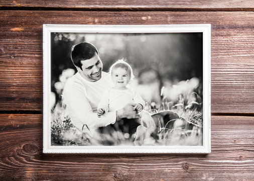 Fathers day composition. Picture frame. Wooden background.