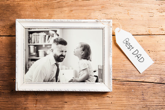 Fathers day composition. Picture frame. Wooden background.