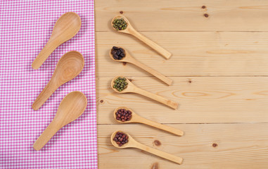 Tablecloth, wooden spoon, on wood textured background