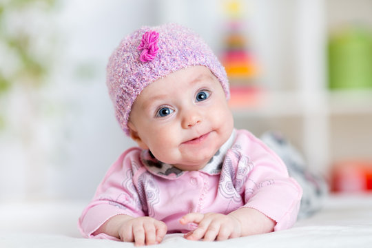 Newborn baby smiling looking at camera