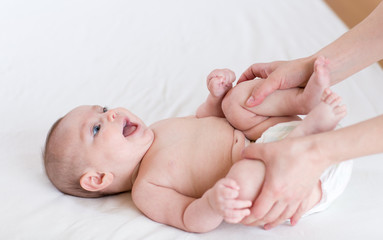 Female doing massage and gymnastic baby