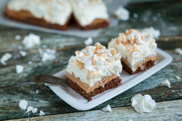 Pieces of cake with cream and meringues