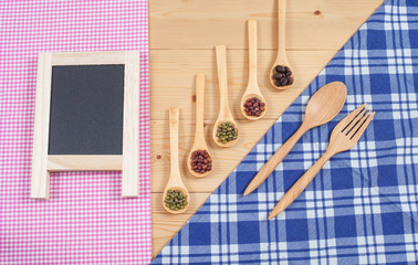 Tablecloth, wooden spoon, on wood textured background