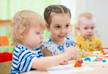 Fototapeta premium kids group doing arts and crafts in kindergarten