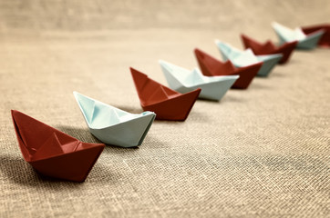 toned colored paper boats glass