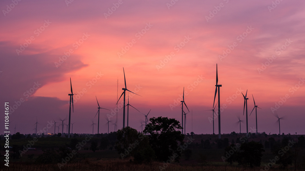 Wall mural Wind turbine power generator at twilight