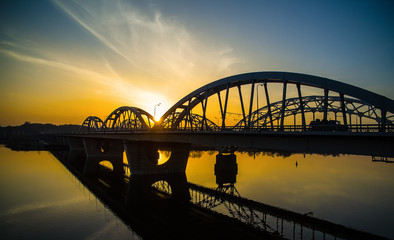 Darnitskiy bridge across Dnepr river against sunset sky. Kiev, Ukraine