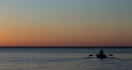 Fototapeta premium Man with the oars on the water in the sea