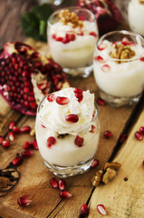 yogurt dessert with walnuts and pomegranate selective focus