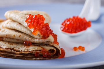 Pancakes with red caviar.Carnival.selective focus.