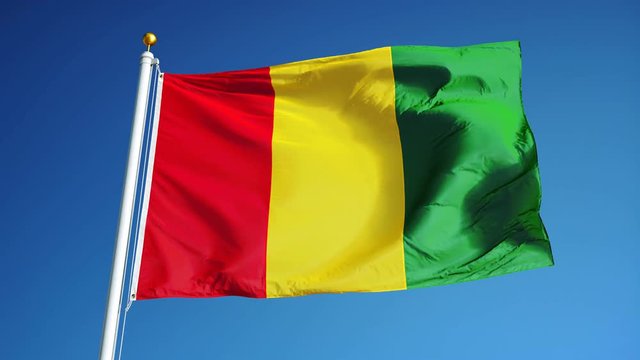 Guinea flag waving in slow motion against clean blue sky, seamlessly looped, long shot, isolated on alpha channel with black and white luminance matte, perfect for film, news, digital composition