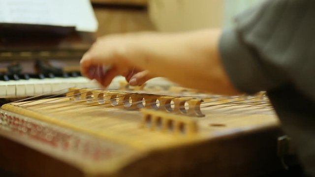 Woman playing the dulcimer in the College of Music