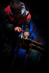 Fototapeta na wymiar Young man working with plasma cutter on steel plate