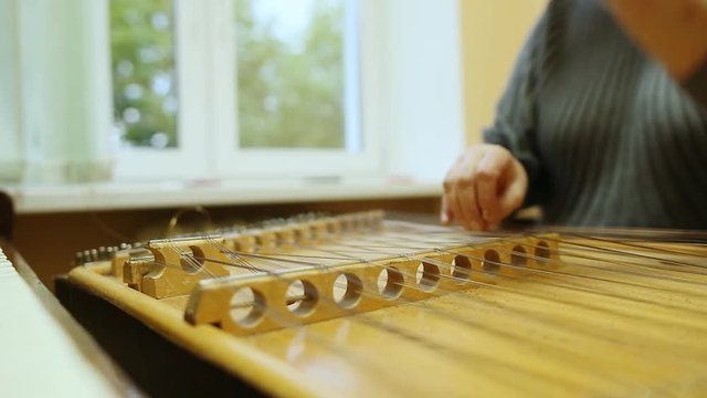 Woman playing the dulcimer in the College of Music