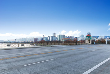 concrete road with cityscape and skyline of portland in blue sky