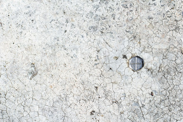 cracked concrete wall with metal bolt