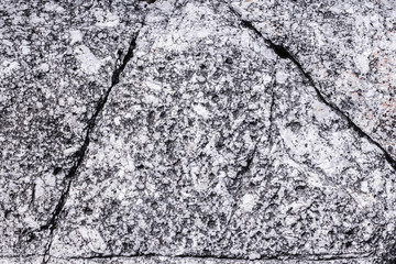 Cracked granite stone in shape of triangle. rock texture backgro