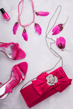 Still life of fashion woman. background.Women's set of fashion accessories in pink color.Shoes with heels and clutch bag.Copy space.selective focus.
