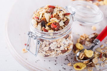 Homemade granola in jar , healthy breakfast of oatmeal muesli, nuts, seeds and dried fruit.selective focus.
