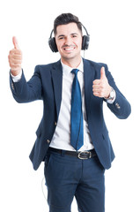 Handsome joyful lawyer listening music and doing double thumbup