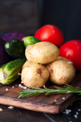 Young potatoes on wooden table