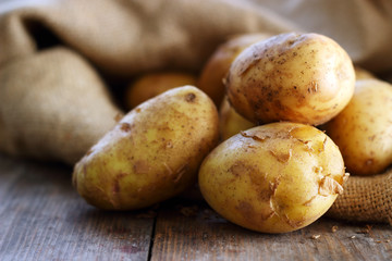 Potatoes on wooden background
