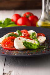 Caprese salad with mozzarella, fresh tomato and basil