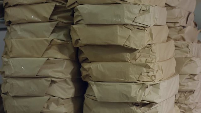 Stack of simple paper packages. Big stack of parcel packages. Mail waiting to be delivered. Perfect order at warehouse.