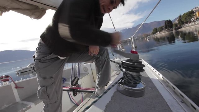 boat woman performs maneuver with winch