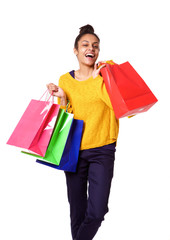 Attractive black woman smiling and holding shopping bags