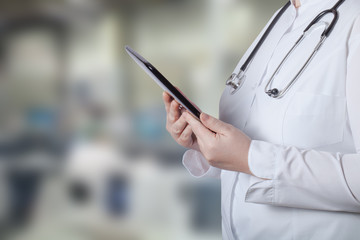 A woman in a white uniform robe with electronic device in her ha