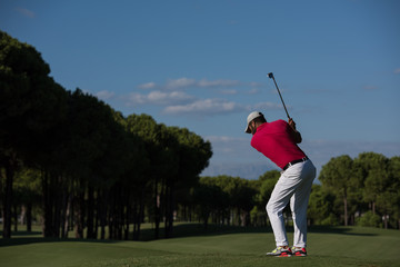 golf player hitting long shot