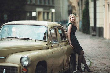 interesting girl standing near old car