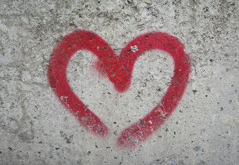 gray stone wall red heart. drawing red heart on a black stone