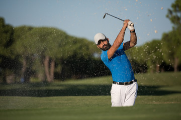 pro golfer hitting a sand bunker shot